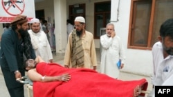 A victim of a bomb attack on an election rally in the northwestern town of Hangu, Pakistan on May 7 is wheeled toward medical assistance.