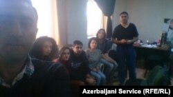 Staff from RFE/RL's Azerbaijani Service are held in their Baku offices on December 26 by state prosecutors who say they have a court order to close the bureau down. 