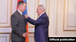 Galust Sahakian (right), speaker of Armenia's parliament, awards the National Assembly's Medal of Honor to Albert Weiler, member of German Bundestag, in Yerevan in August 2016.