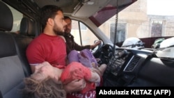 A wounded Syrian girl is transferred to a hospital following a reported air strike by regime forces and their allies on Maaret al-Noman in Idlib Province on May 30. (AFP/Abdulaziz Ketaz)