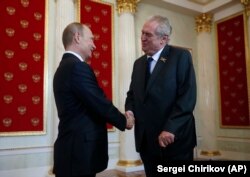 Russian President Vladimir Putin (left) welcomes Czech President Milos Zeman during a ceremony in the Kremlin prior to the Victory Parade marking the 70th anniversary of the defeat of the Nazis in World War II in May 2015.