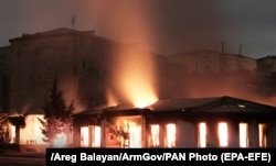 Buildings burn in Stepanakert after reported shelling by Azerbaijani artillery on October 4