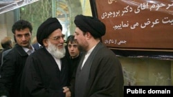 The former head of Iran's judiciary Mahmud Hashemi Shahrudi (left) in conversation with Hassan Khomeini, the grandson of Iran's first supreme leader, Ayatollah Ruhollah Khomeini.