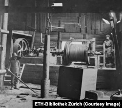 Workers inside an oil derrick near Baku