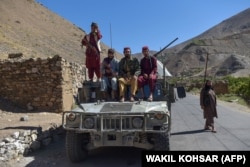 Taliban fighters sit atop a Humvee in Panjshir Province on September 15, 2021, days after the militants announced the capture of the last province resisting their rule.