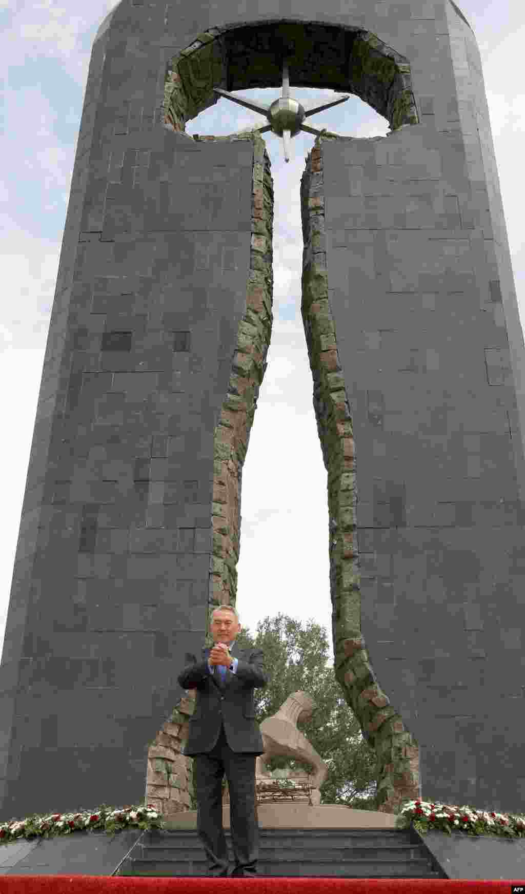 Kazakh President Nursultan Nazarbaev stands before a monument to the nuclear tests in Semipalatinsk in June 2009.