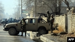 Afghan security forces near the main gate of the National Directorate of Security, where an accidental explosion in an arms depot shook central Kabul in December