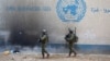 Israeli soldiers walk inside an evacuated compound of the United Nations Relief and Works Agency for Palestine Refugees (UNRWA) in the Gaza Strip. (file photo)