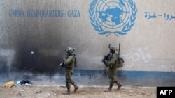 Israeli soldiers walk inside an evacuated compound of the United Nations Relief and Works Agency for Palestine Refugees (UNRWA) in the Gaza Strip. (file photo)