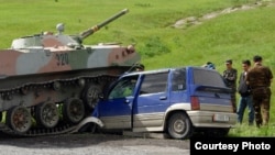 A tangle between a car with Kyrgyz license plates and an Uzbek tank in the Sokh enclave in 2010.