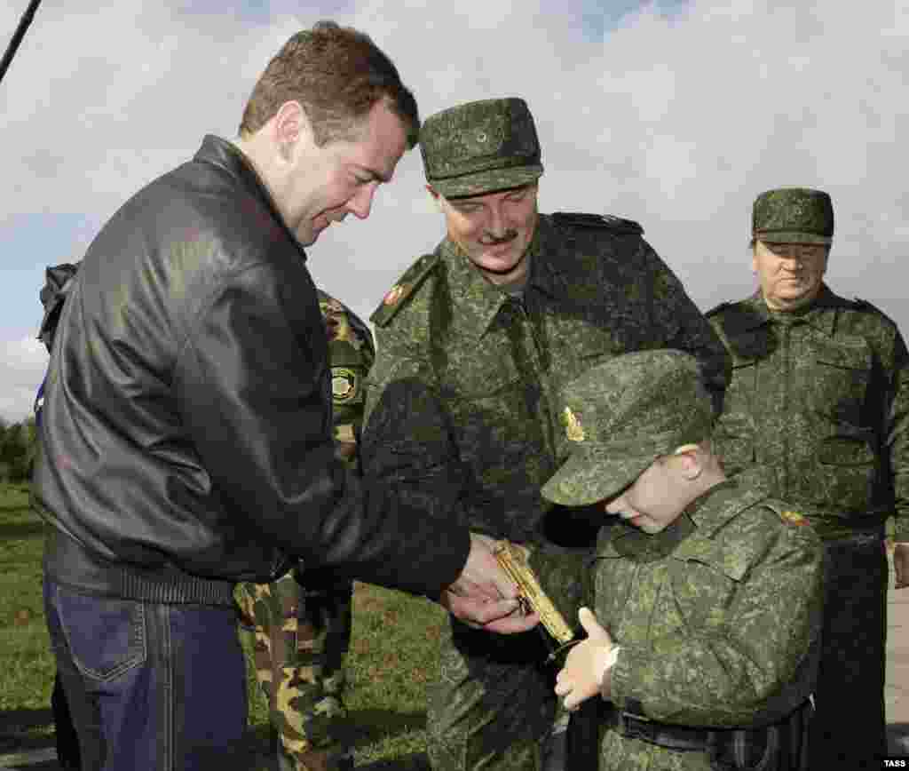 Lukashenka (right), Kolya, and then-Russian President Dmitry Medvedev observe joint military exercises in September 2009.