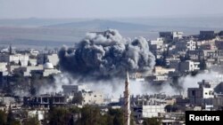 A presumed air strike by the U.S.-led coalition strikes the Syrian town of Kobani on October 23.