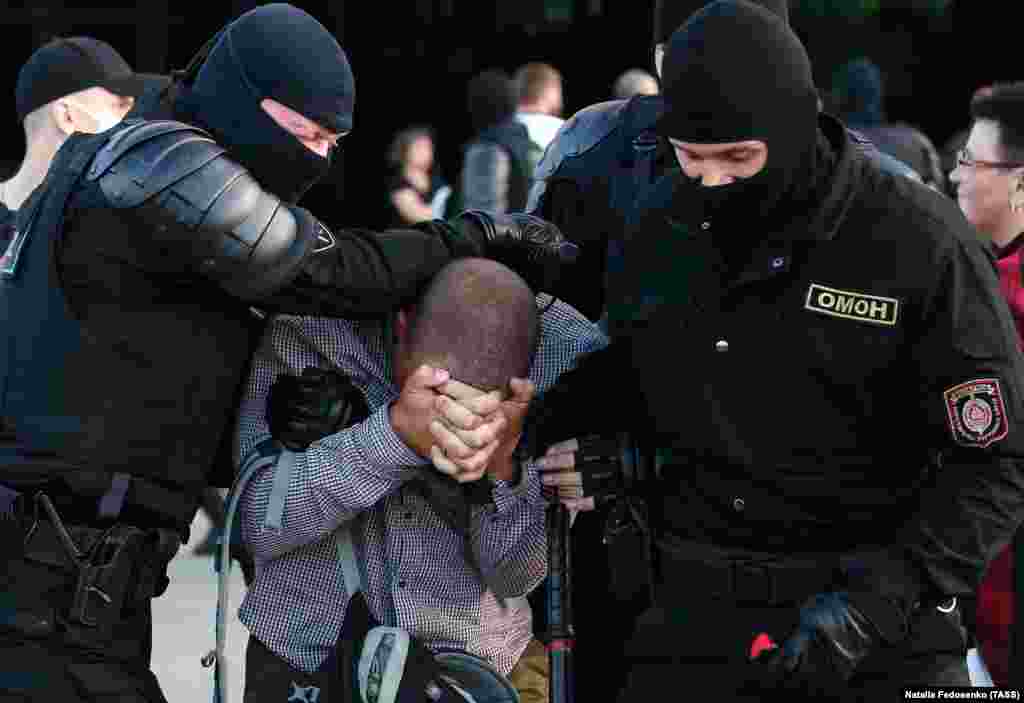 A protester is dragged away by security forces in Minsk.