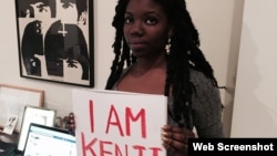 A woman holds an "I Am Kenji" sign on social media in support of the campaign to free Japanese hostage journalist Kenji Goto, who is being held by Islamic State (IS) militants threatening to kill him if their demands are not met.