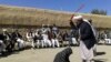 An Afghan judge whips a woman in front of a crowd in Ghor Province in 2015.