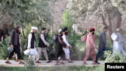 Newly freed Taliban prisoners walk out of Pul-e Charkhi prison in Kabul on August 13.