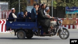 Residents of Kunduz leave the city amid ongoing fighting between Taliban militants and Afghan security forces in Kunduz on October 5.