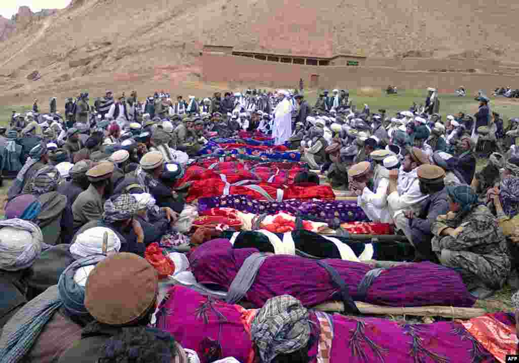 Miners sit next to the bodies of the killed miners.