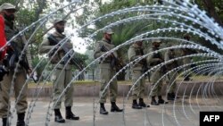 Pakistani paramilitary soldiers cordon off the area during the funeral prayer of slain Punjab Governor Salman Taseer in Lahore on January 5.