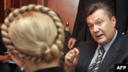 Viktor Yanukovych, who later went on to defeat Yulia Tymoshenko in the 2010 presidential election, speaks with her during talks in Kyiv in 2007.