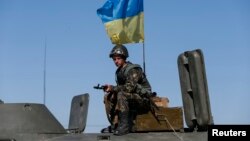 A Ukrainian serviceman stands at a checkpoint near Debaltseve, a city in the Donetsk Oblast.