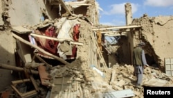 An Afghan man inspects a house destroyed during clashes between Afghan security forces and the Taliban in Kunduz in November.