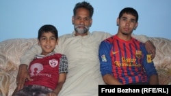 Mohammad Isaq with his sons, Sadiq and Fahim