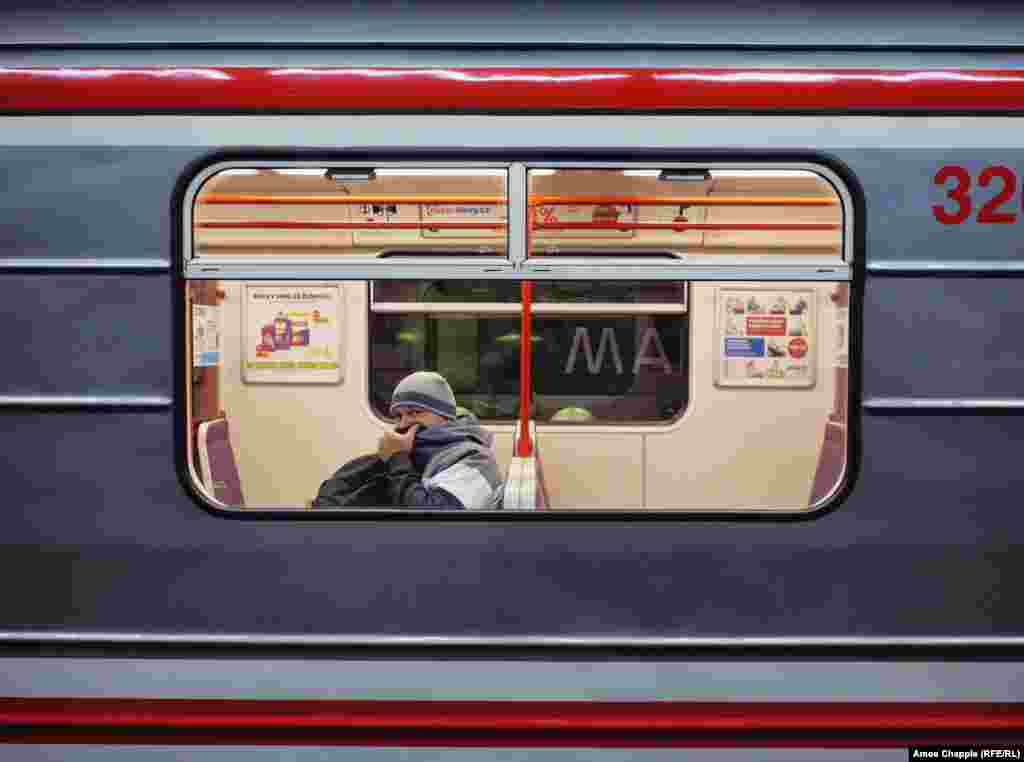 A man covers his face inside the subway. The Czech government has banned most nonessential travel throughout the country.&nbsp;