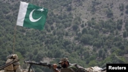 A Pakistani soldier takes up position in Tora Warai, a town in Kurram Agency, earlier this month. Tribal elders were told it was safe to return to the area and that the government was in control.