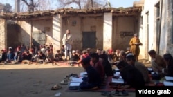 Children attend classes at a 100-year-old school in Pakistan's Shabqadar district of Khyber Pakhtunkhwa, where newly installed provincial authorities have pledged to restore violent jihadist content to textbooks.