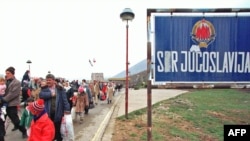 Kosovar refugees cross the border between Yugoslavia and Albania in April 1999.