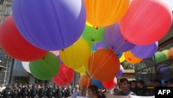 Gay-rights activists are surrounded by police during a rally against homophobia in Kyiv on May 18.