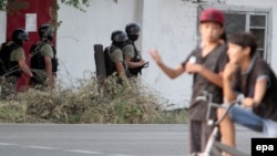 Soldiers secure an area during an antiterrorist operation aimed at eliminating armed militants in a Bishkek neighborhood on July 16.