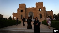 Iraqi Christians leave St. Joseph's Church after a mass in Irbil, the capital of the autonomous Kurdish region, on July 20.