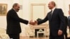 Armenian Prime Minister Nikol Pashinian (left) shakes hands with Russian President Vladimir Putin at a meeting in Moscow in June. 