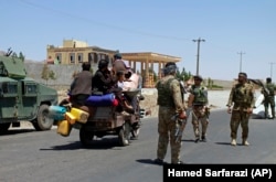 Afghan civilians fleeing the city of Herat, which was captured on August 12.