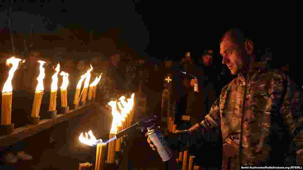 A man lights candles in the central square of the ghost town of Pripyat near the Chernobyl power plant on April 26.