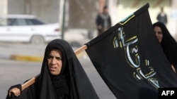 Carrying the Shi'ite banner in Iraq?