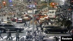 A surveillance photo shows a Nissan sports-utility vehicle (right) containing a bomb on Times Square in New York.