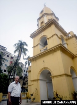 Martin poses in front of the freshly repainted church in 2008.