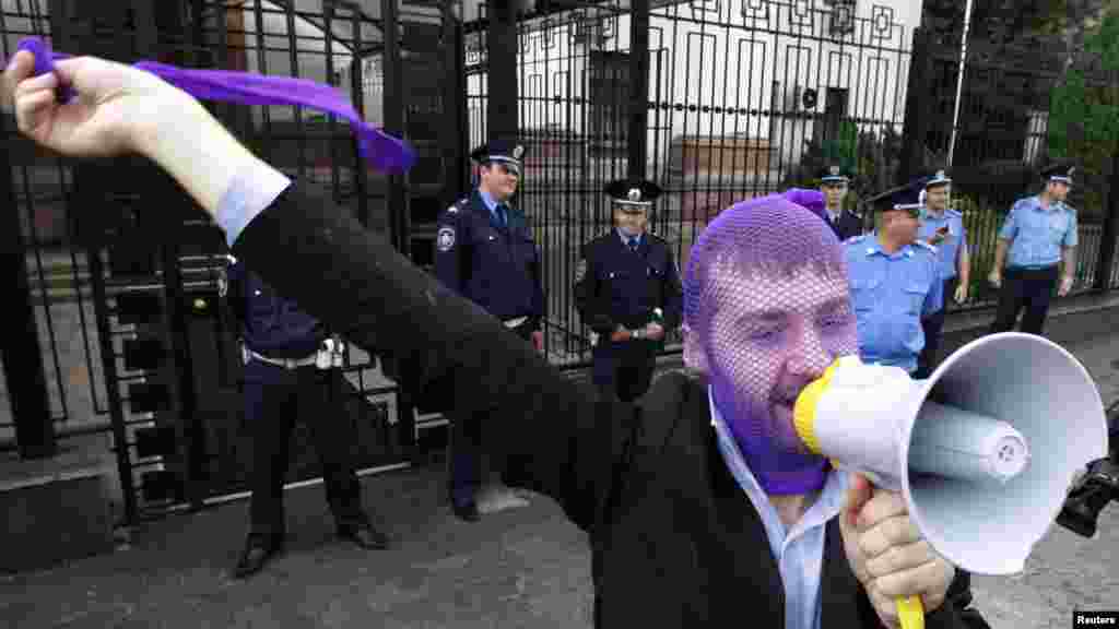 A Pussy Riot supporter shouts slogans during a gathering outside the Russian Embassy in Kyiv on August 17.