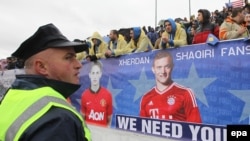 A banner with portraits of Bayern Munch's Xherdan Shaqiri (right) and Manchester United's Adnan Januzaj, both of Kosovo origin, is displayed prior to the international friendly soccer match between Kosovo and Haiti.