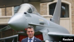 NATO Secretary-General Anders Fogh Rasmussen prepares to speak to the media in Wales.