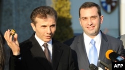 Georgian Prime Minister Bidzina Ivanishvili (left), flanked by Defense Minister Irakli Alasania, speaks to the media in February.