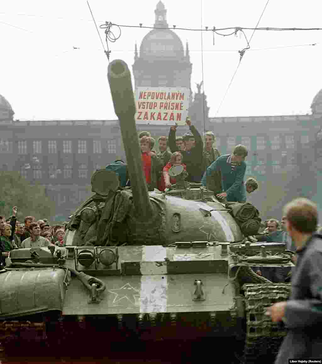 Czechs ride a Soviet tank on Wenceslas Square at around 8-9 a.m. on August 21. At this stage, the atmosphere was still relatively relaxed, according to Hajsky.&nbsp;&quot;Lots of people essentially still didn&#39;t realize that it was a planned attack,&quot; he says. &quot;They thought it was a military exercise or something.... In this photo, you can see that there are kids on the tank. Like they were having a go on a fairground ride.&quot;