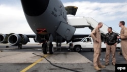 U.S. soldiers stand in front of military planes at the Manans air facilities near the Kyrgyz capital, Bishkek.