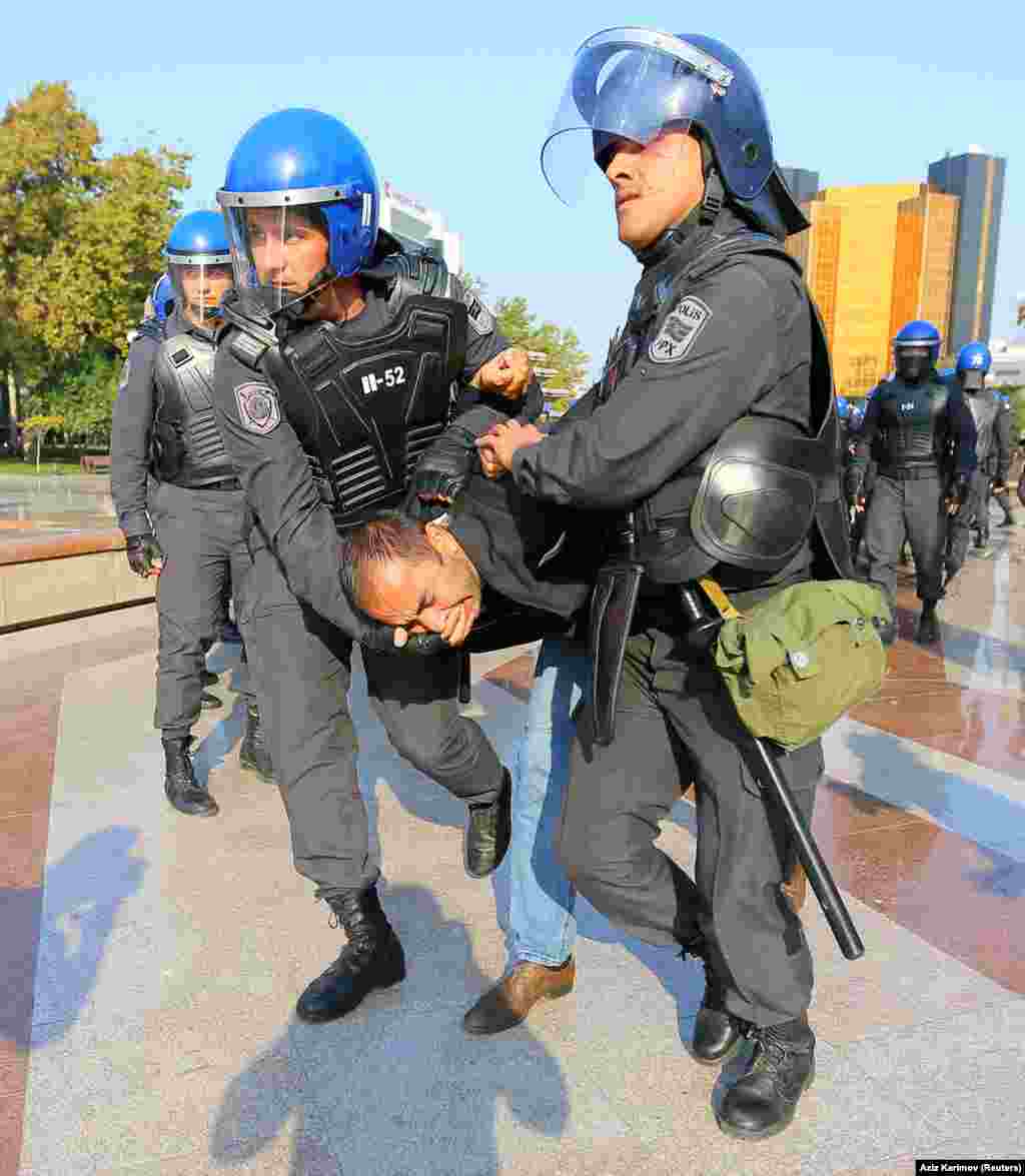 Some of the protesters were punched in the head as they were hauled into buses by police in riot gear.