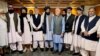 Former Afghan President Hamid Karzai (fifth left) and the ousted government's peace envoy, Abdullah Abdullah (fifth right), meet with members of the Taliban after the militants seized power in Kabul.