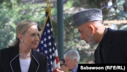 U.S. Secretary of State Hillary Clinton (left) speaks as Afghan President Hamid Karzai listens during a press conference at the presidential palace in Kabul on July 7.