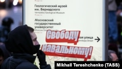 A protester next to a map with a "Free Navalny!" sticker attached at a rally in central Moscow on April 21.